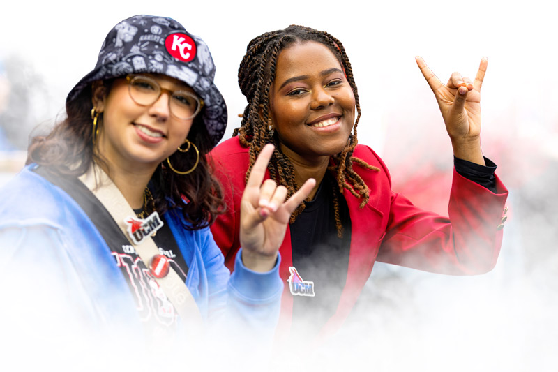 Two student giving the "snouts out" hand sign