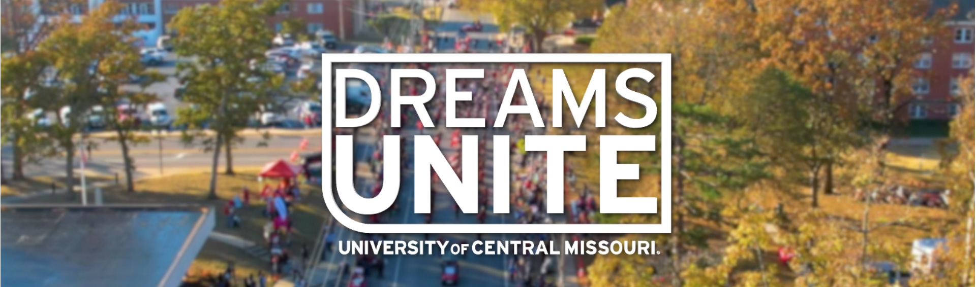 The Dreams Unite logo over and aerial view of a parade The Dreams Unite logo over and aerial view of a parade
