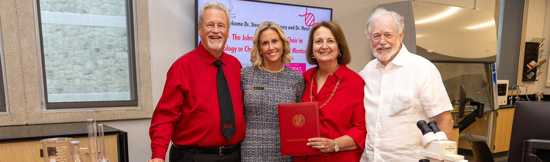 Dr. Stephen Lacey, Courtney Goddard, Ann Lacey, and John Hess Ph.D. signing an endowment agreement