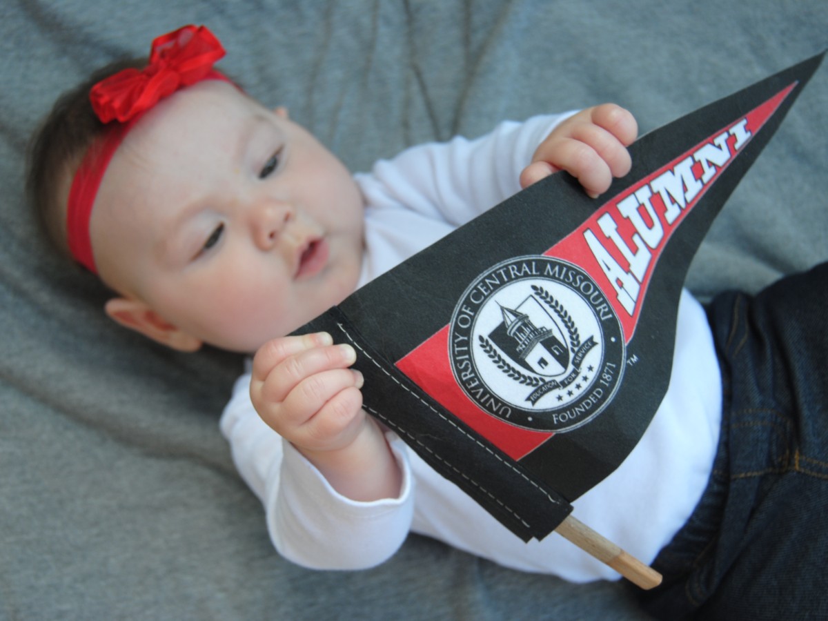 UCM Baby News Photo of baby holding UCM Alumni pennant