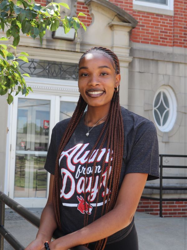 student wearing alum from day one shirt